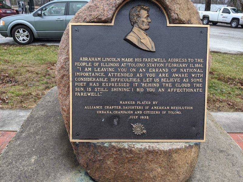 Image: A boulder with a plaque. The plaque features the bust of Abraham Lincoln and details his farewell address to the people of Illinois. Photo by Katriena Knights.