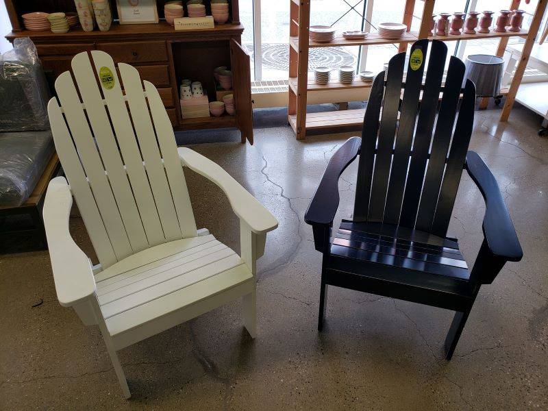 Image: Two low sitting outdoor patio chairs. One is ivory, the other is dark blue. Photo from Champaign ReStore Facebook page. 