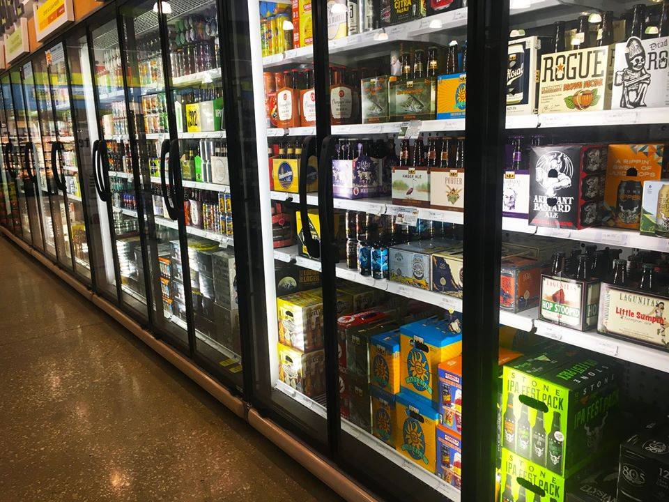 A row of refrigerators holding cold beers along the right side of the photo. Photo from Harvest Market's facebook page. 