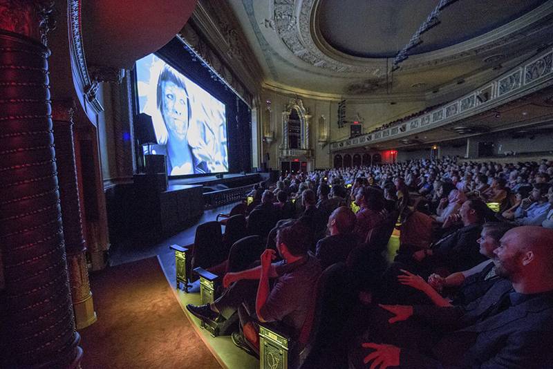 Image: Photo of audience at past Pens to Lens festival at the Virginia Theatre. Photo from Pens to Lens website