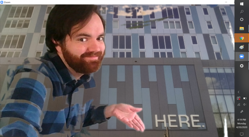 A screenshot of the author in front of the building facade, gesturing toward the word 