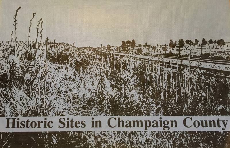  The cover of the Historic Sites in Champaign County booklet. Black printed image and text set on a blue blackground. The image is the Illinois Central Railroad Tracks north of Rantoul with surrounding prairie. 