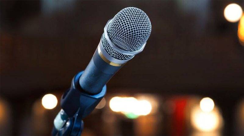 Image: Close-up photo of microphone in a dark room. Photo from Poets at the Post Facebook page.