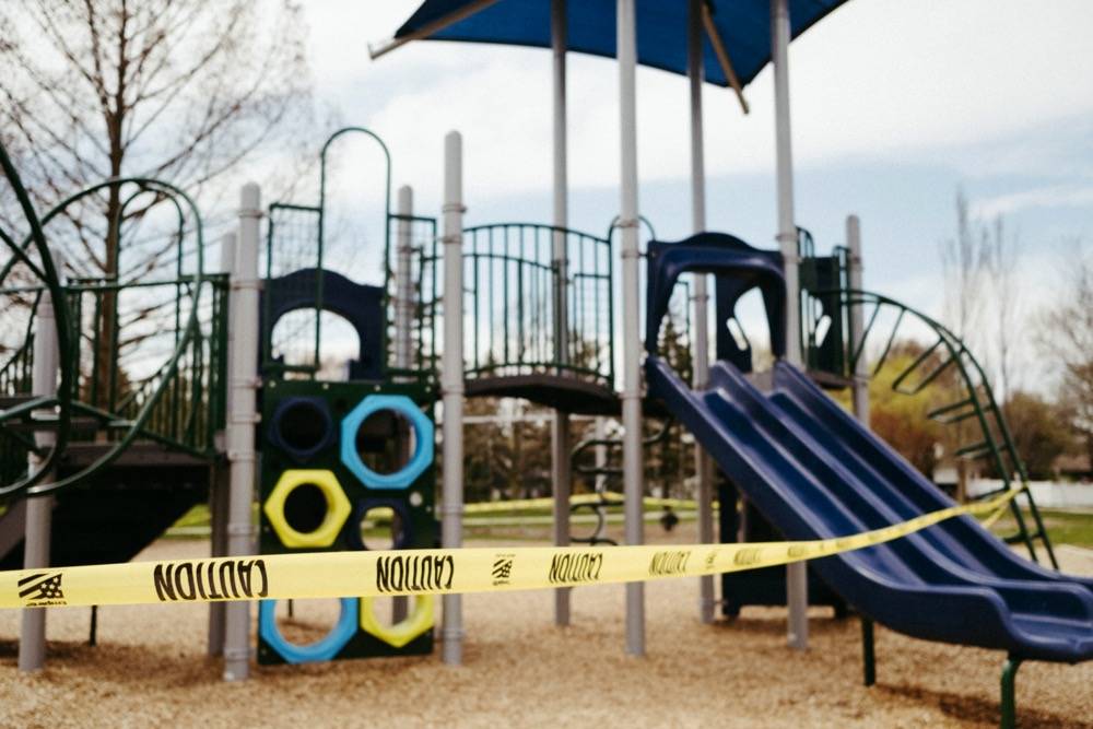 IMAGE: A playground, wrapped in yellow caution tape. Photo by Anna Longworth.