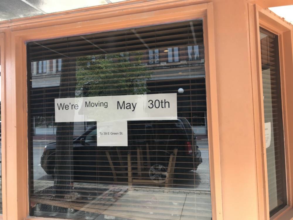 IMAGE: Window with signage reading We're Moving May 30th to 39 E. Green Street. Photo by Patrick Singer.