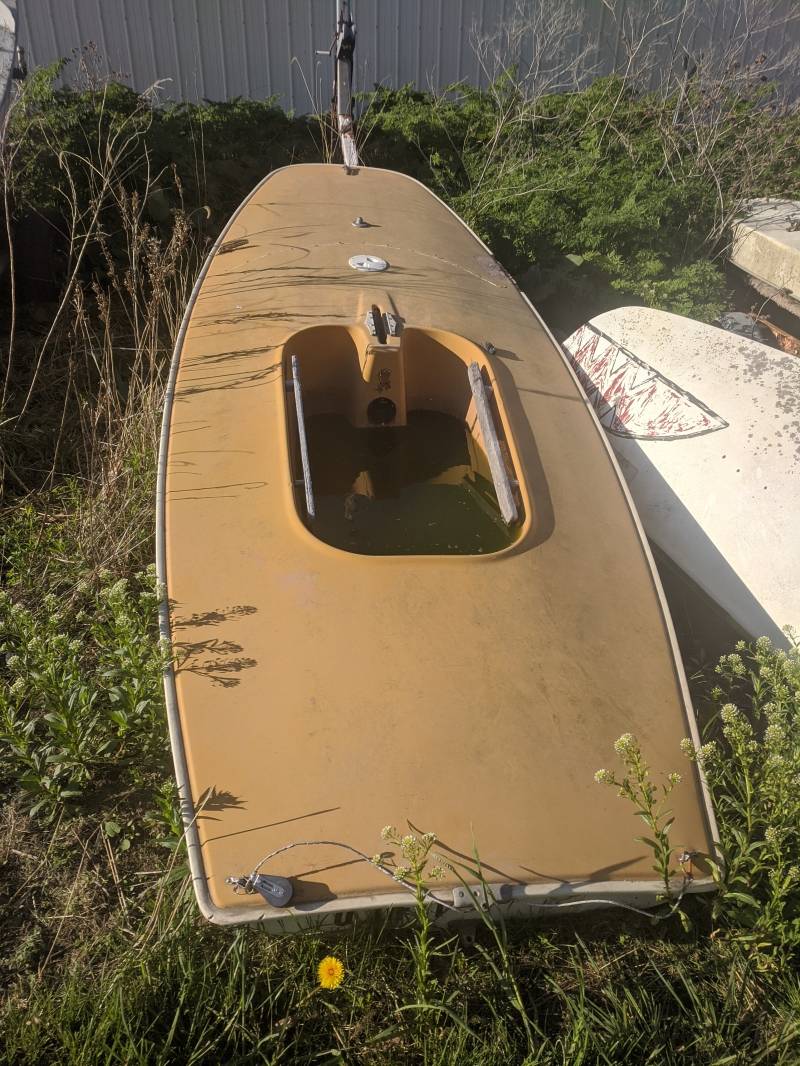 View from above of a tan colored boat with a one person seat. Photo by Tom Ackerman.