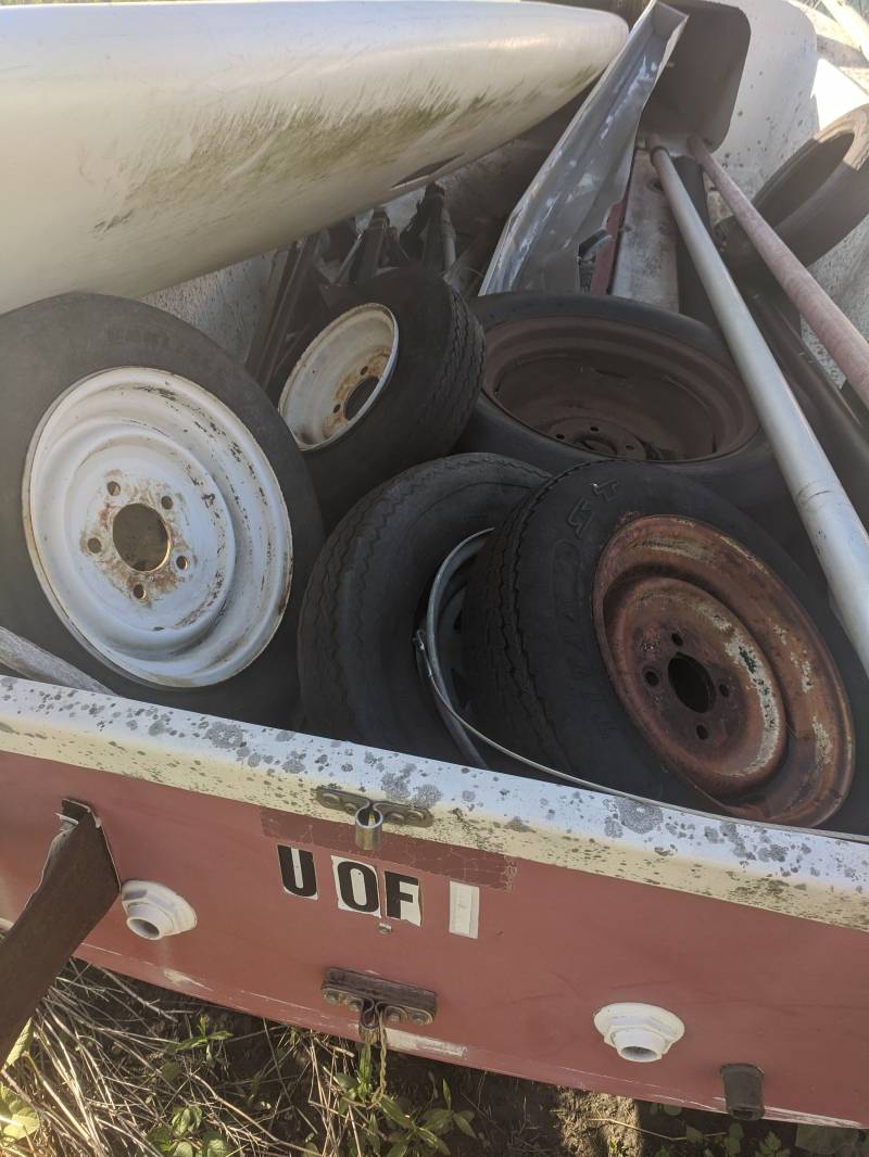 A close up of the interior of a boat, it is filled with old tires. Photo by Tom Ackerman.