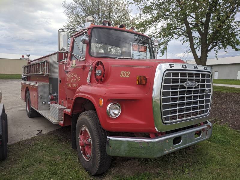 An old fashioned red Ford fire engine with a ladder along this side. Photo by Tom Ackerman.
