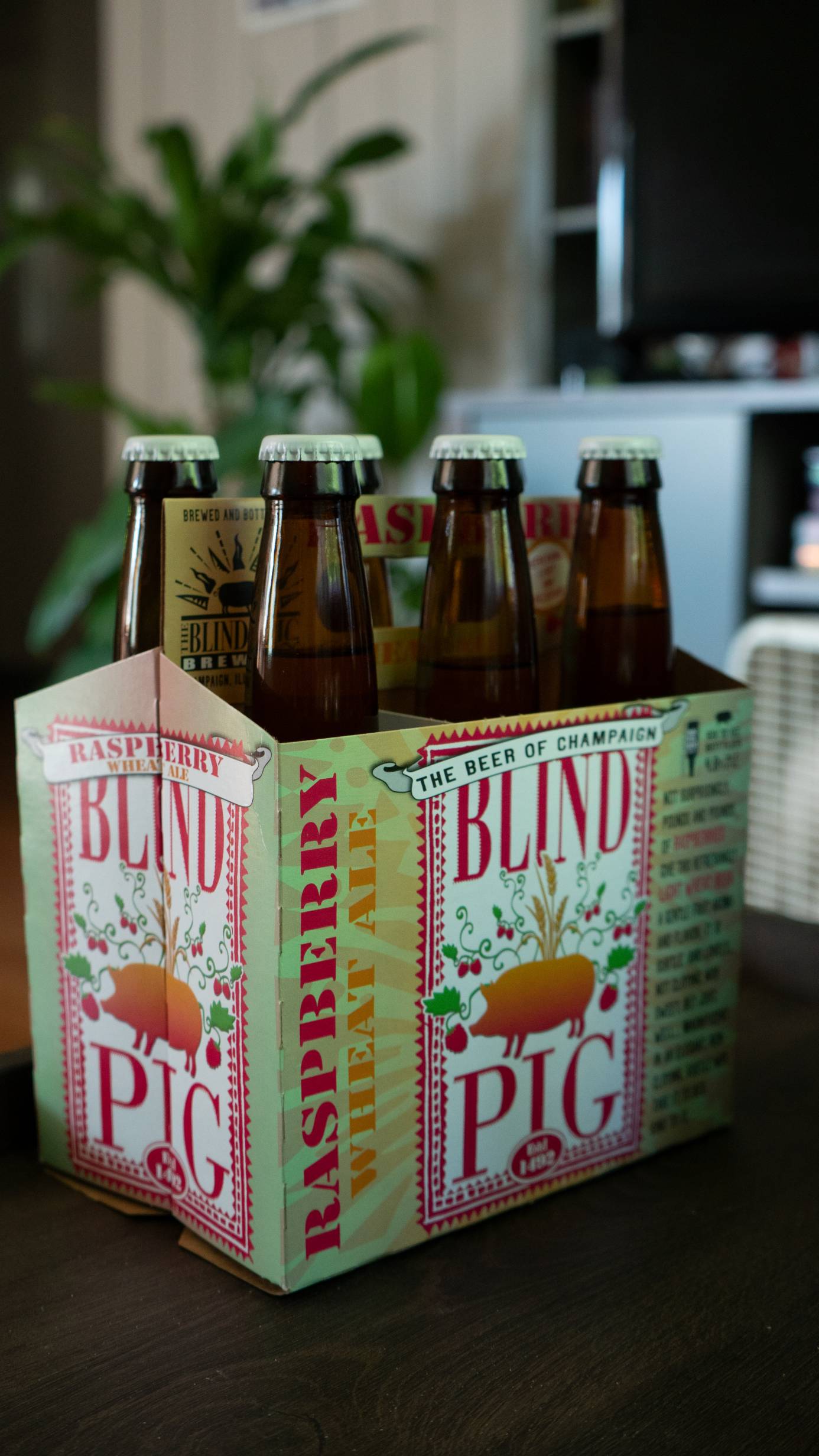 A six pack of Bling Pig's raspberry wheat ale sits on a counter. Photo by Jordan Goebig.