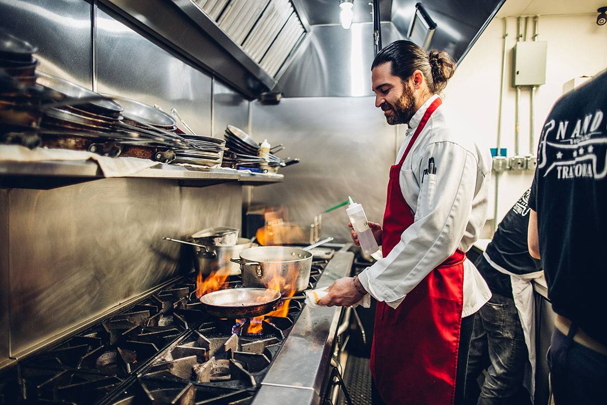Chef Vullo in the kitchen cooking over a hot stove. Photo from Nando Milano's website.