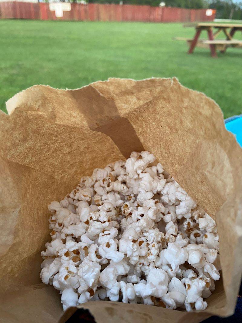 A view of the inside of a brown paper bag filled with popcorn. Photo by Julie McClure.