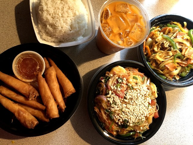 Takeout order of shrimp in a blanket, ginger chicken stir fry, yum woon sen, and a Thai iced tea.. Photo by Remington Rock.