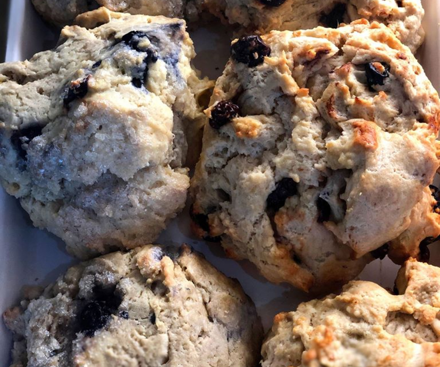 Freshly baked blueberry scones are lined up next to each other, lightly toasted on the top. Photo by Sweet Indulgence Facebook page.