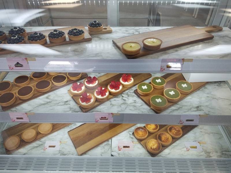 Tasty Tart display case showing all eight tart varieties neatly lined up in separate sections. Photo by Matthew Macomber.