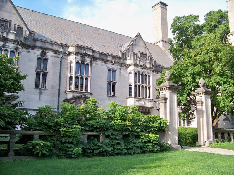 Wesley Foundation Building, taken facing southwest from Green Street. Limestone Gothic and Renaissance construction with elaborate cornices and other decorative elements.  Walkway extends between two stone gate posts. Two extended bay windows. Photo by Rick D. Williams.