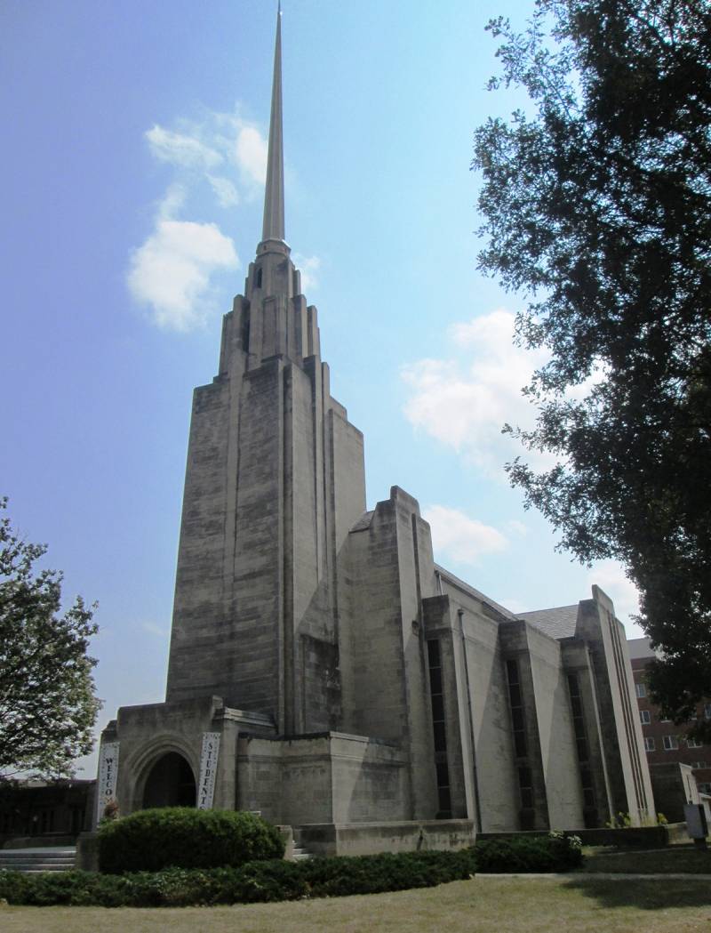 Wesley United Methodist Church, taken facing southeast from Green Street  Dark stone in high-rising modernist style.  Extremely tall, narrow center steeple.  Photo from Wikipedia Commons. 