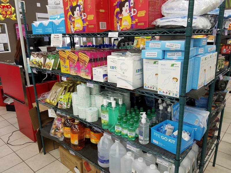 Discount items on sale near the Fresh International Market checkout, including masks and hand sanitizer. Photo by Matthew Macomber.