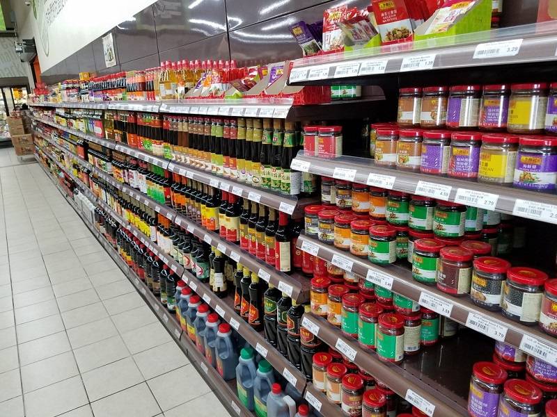 Aisle in other half of store with many sauces on display amongst the five shelf levels. Photo by Matthew Macomber.