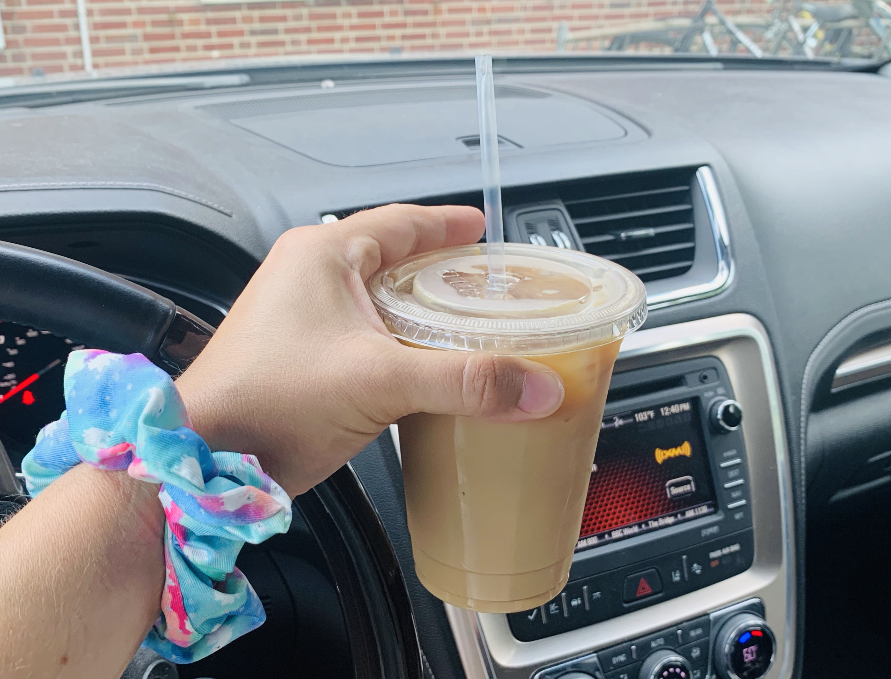 The author holds a large iced caramel latte with skim milk and caramel from Caffe Paradiso in her vehicle. Photo Stephanie Wheatley.