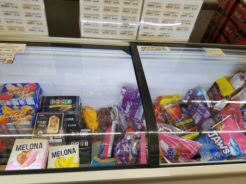 Various fruity frozen treats in the chest freezer with the Melona brand prominently displayed. Photo by Matthew Macomber.