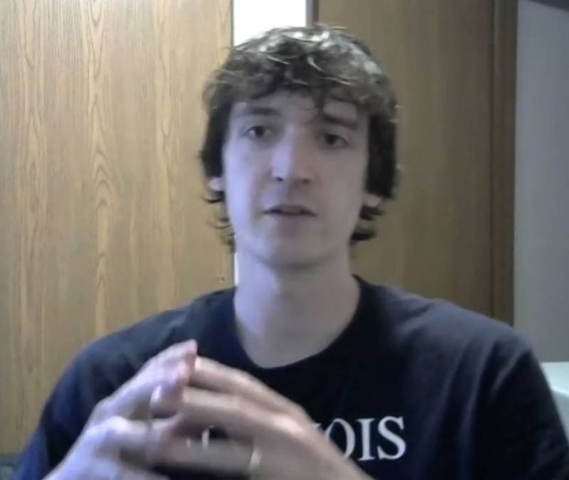 A screenshot of a white man with brown hair. He is wearing a navy blue t-shirt. Screenshot by Cope Cumpston.