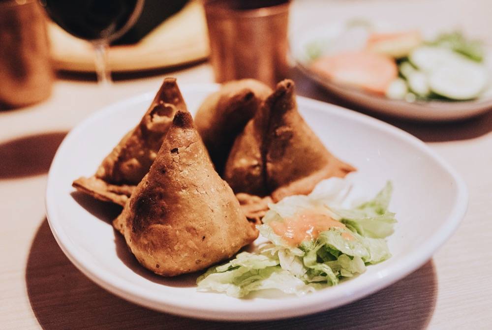 Samosas are a classic appetizer at Kohinoor. Samosas are crispy pastries stuffed with soft savory potatoes and peas. Photo by Anna Longworth.