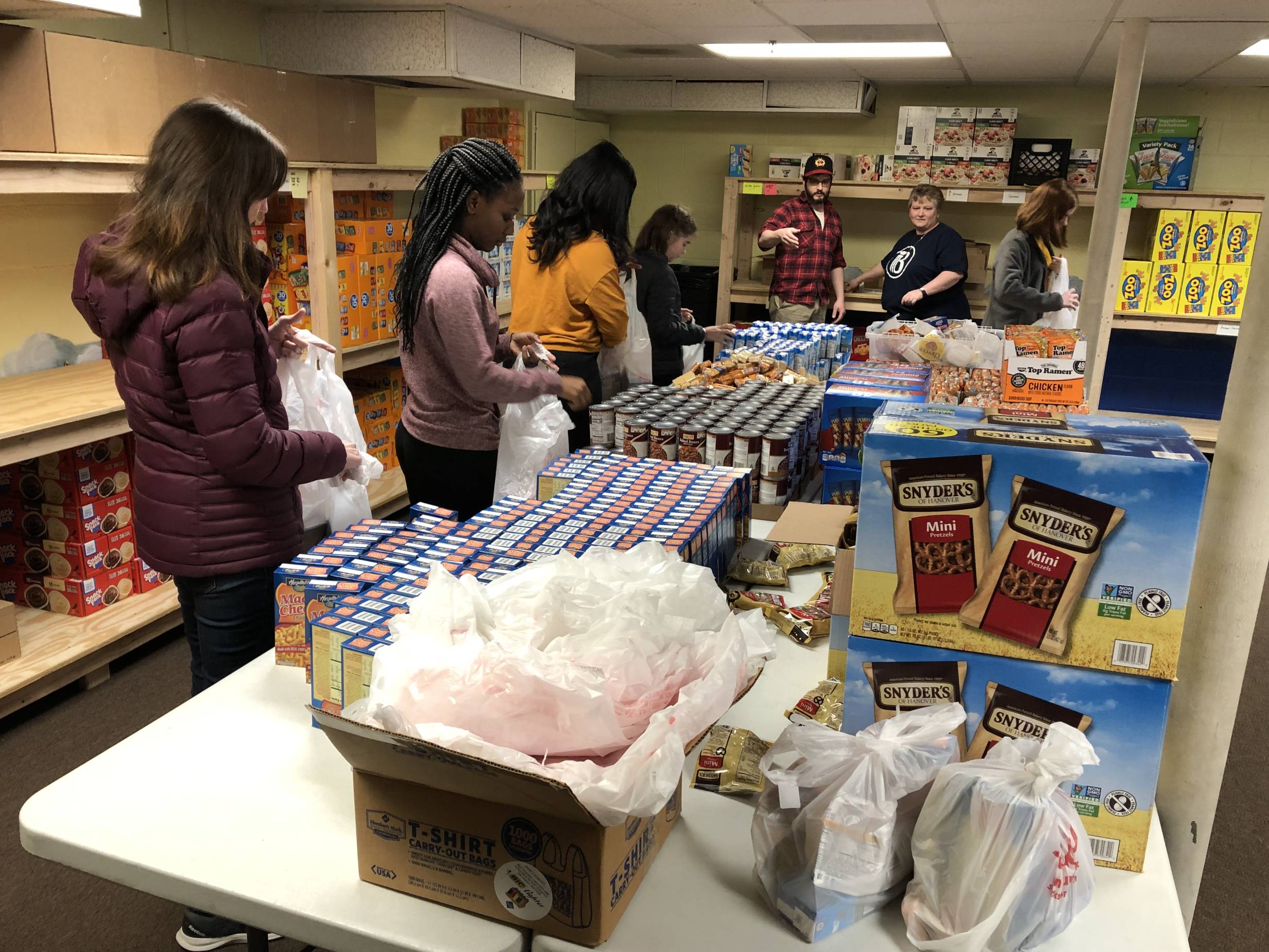 Several volunteers fill bags for food insecure children in Champaign. Photo provided by Feeding Our Kids.