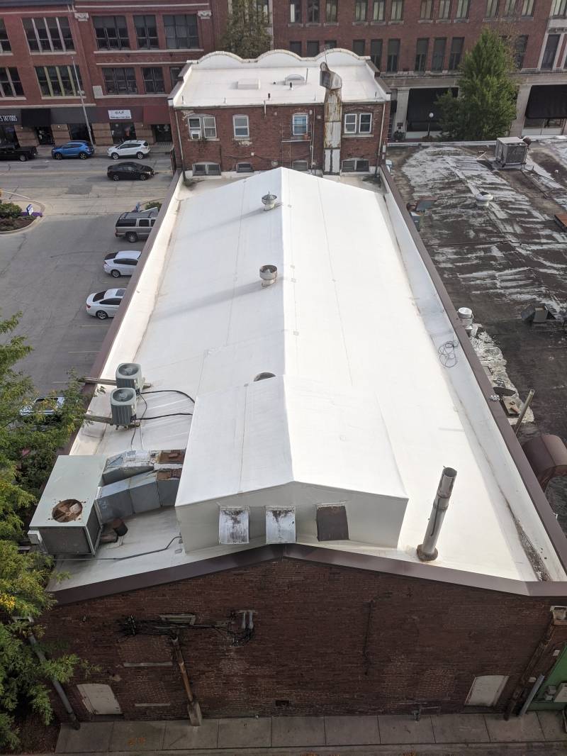 A view of the rear facade of the Art Theater with brown brick and a white roof. Photo by Tom Ackerman.