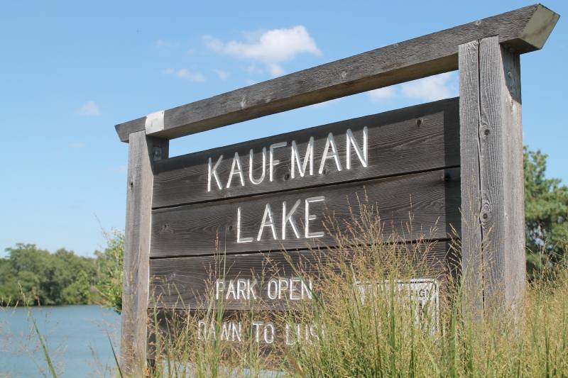 A wooden sign stating Kaufman Lake