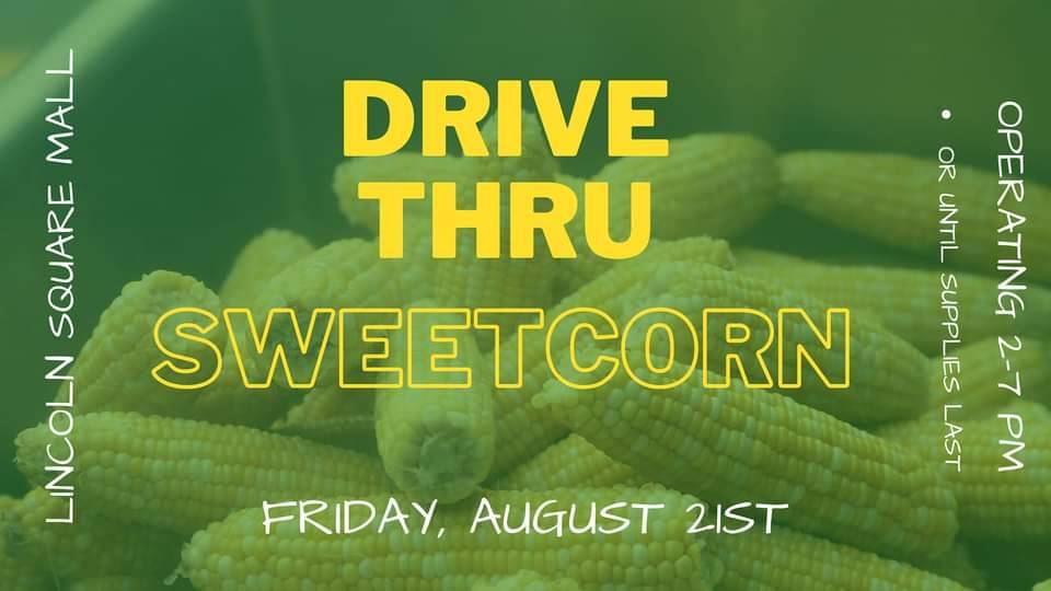 Several shucked ears of corn are in the background of this header image for the Sweetcorn Festival held in Urbana, Illinois. A green filter overlays on the image of the corn cobs, and the words read 