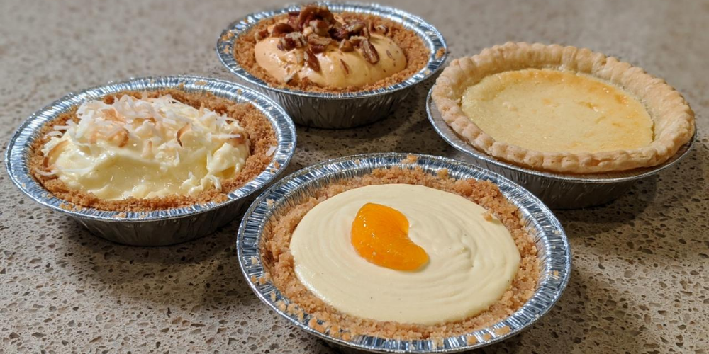 Four pies placed on a sand colored counter. Photo by Thomas Nicol.