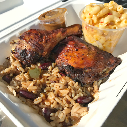 Jerk chicken $5 Flavor Box with rice&#039;n peas and baked to perfection mac 'n cheese, jerk sauce on the side. Photo from Caribbean Grill's website.