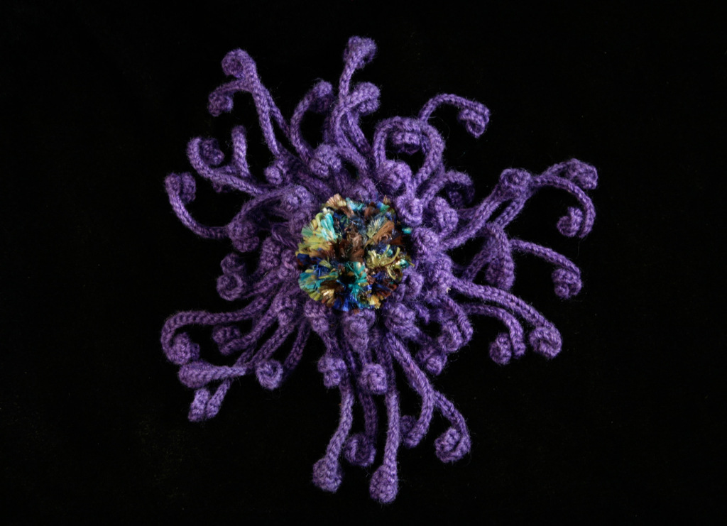 Photo of purple crochet octopus-like creature. Photo courtesy of the Institute of Figuring.