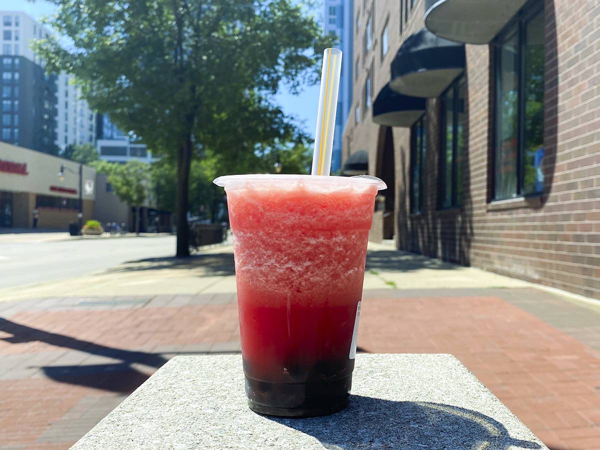 A frosty watermelon smooth from Rokee Cafe sits on a gray square on Green Street by the University of Illinois. Photo by Chantal Vaca.