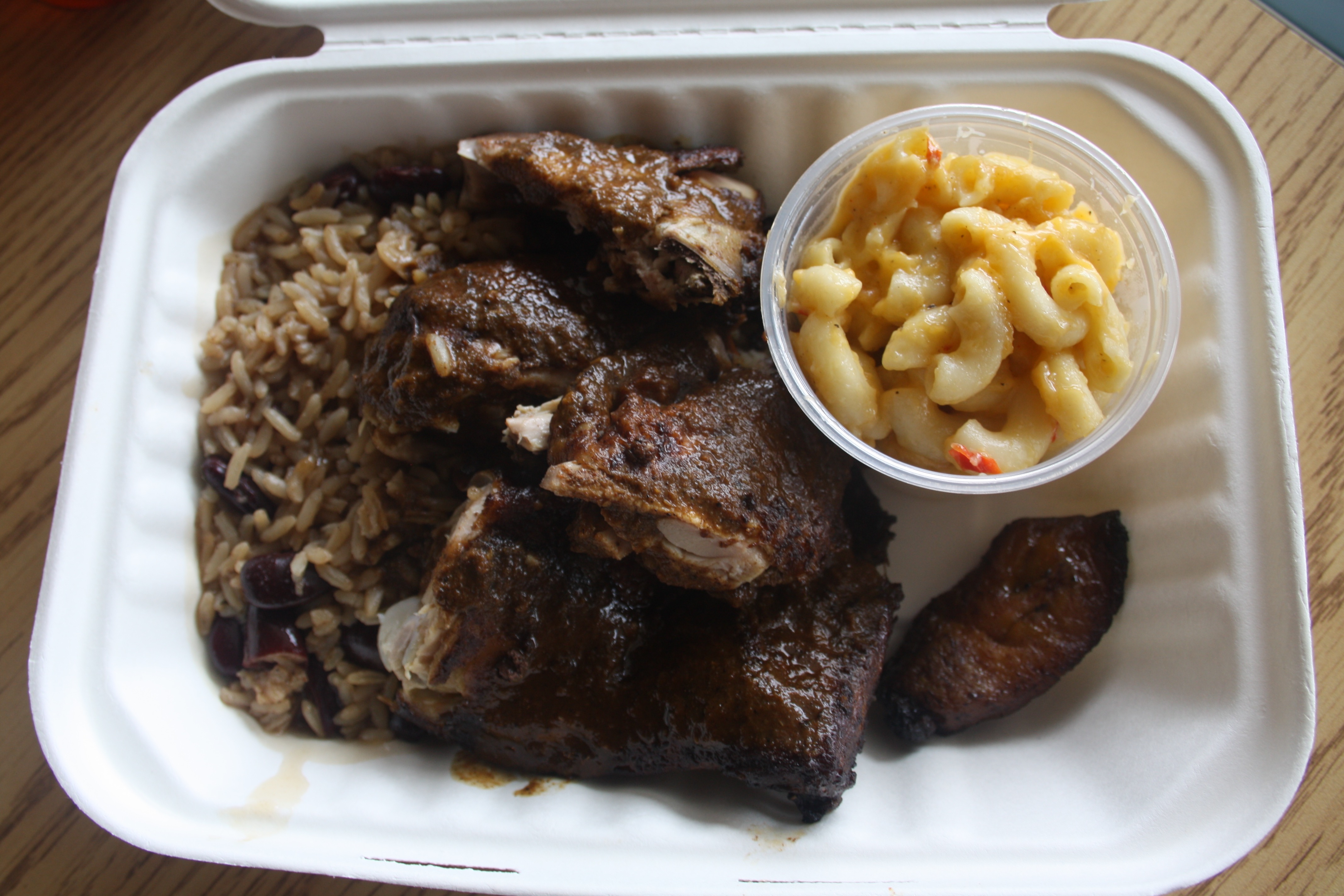 Jerk Chicken with a crispy dark skin served with baked mac and cheese and spicy 'n peas. Photo by Rebecca Wells.