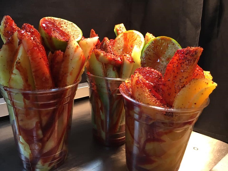 Chamoyada, a dessert with mango, lime, and dry red pepper flakes in a plastic cup. Photo by El Oasis.