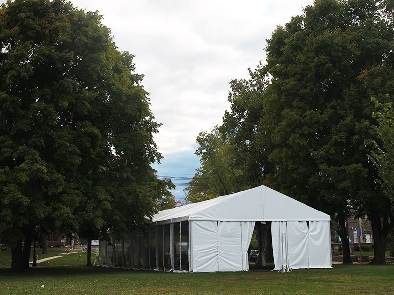 a tent for COVID testing sits on the lawn of the park 