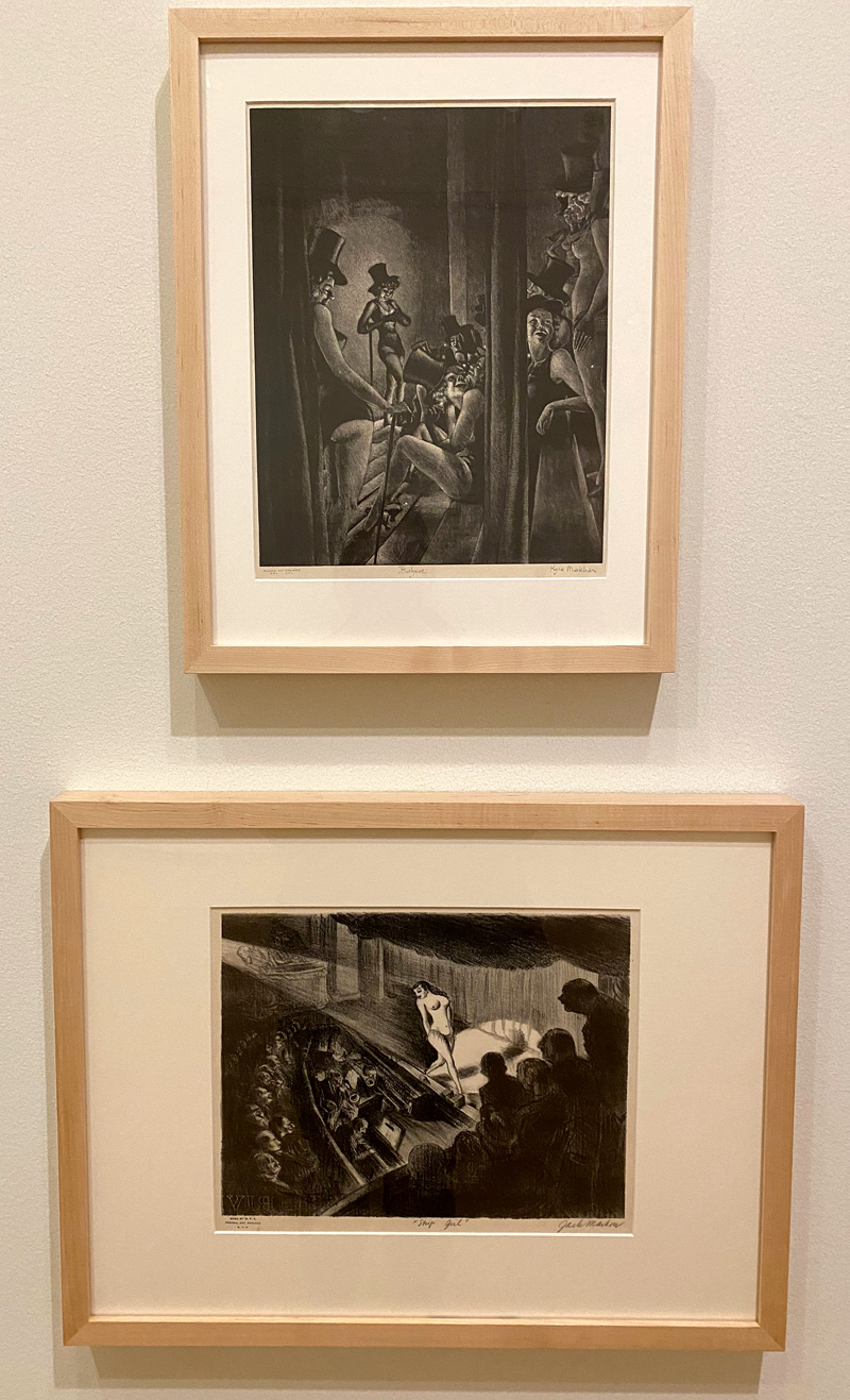 Two prints are framed in light wood frames and hung stacked vertically with Kyra Markhamâ€™s Burlycue above Jack Markowâ€™s Strip Girl. Each work features burlesque dancers. Photo by Jessica Hammie. 