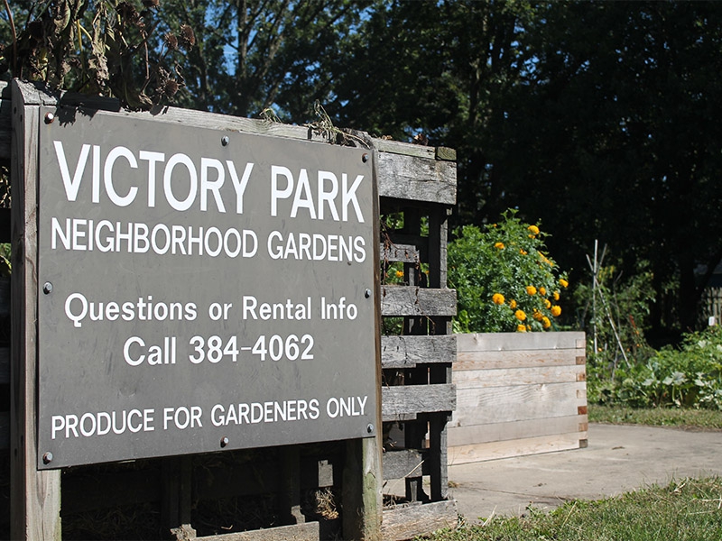A picture of the Victory Gardens sign with contact information on it 