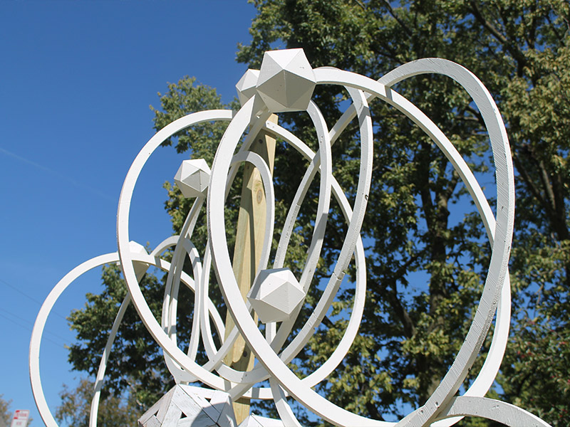 A picture of a sculpture that has many connecting white circles