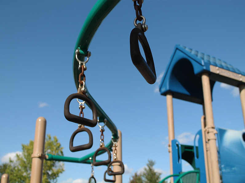 playground equipment, viewed from beneath monkey bars/swings of sorts
