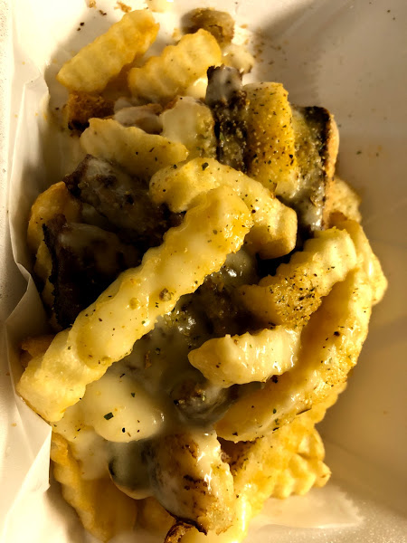 A horseshoe with lots of seasoned fries from Come Get This food truck. Photo by Remington Rock.
