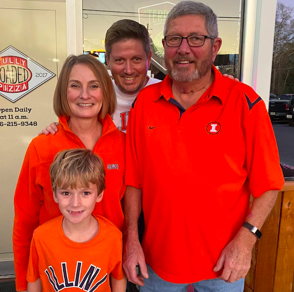 a picture of the author with his parents and son wearing Illinois sports clothing