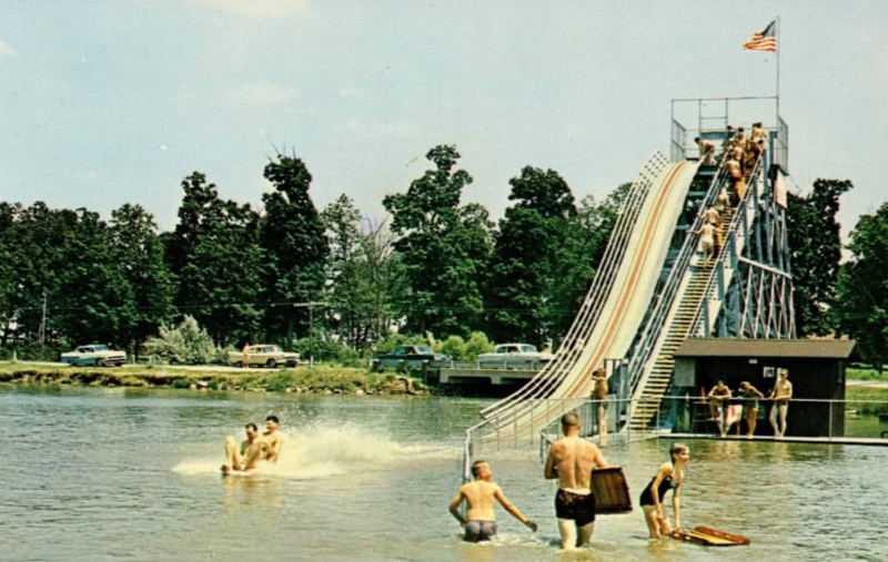a water slide from the 1960s is implanted into the shallow part of a lake 