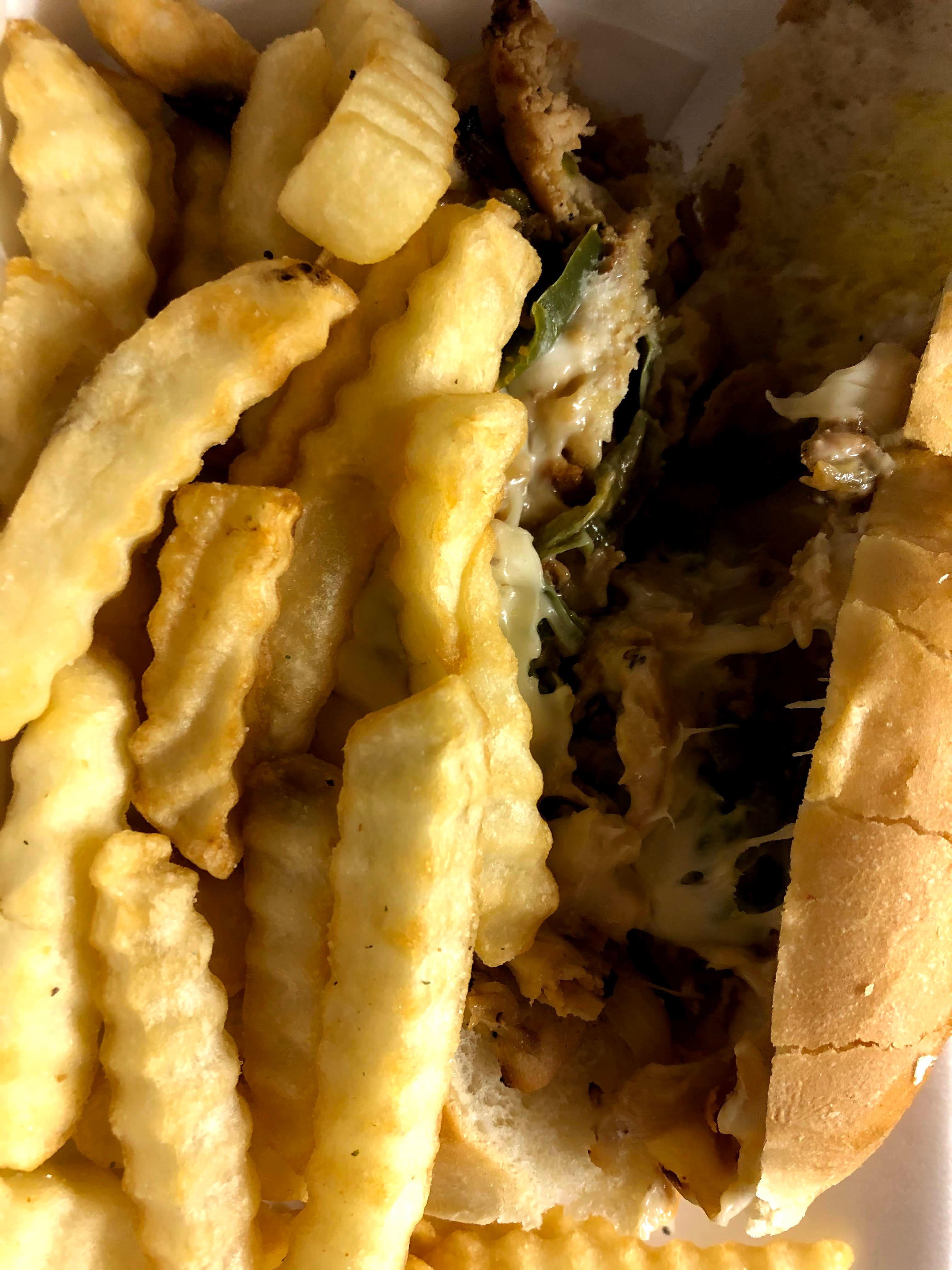 A close up of french fries and cheesesteak from Come Get This. Photo by Remington Rock.