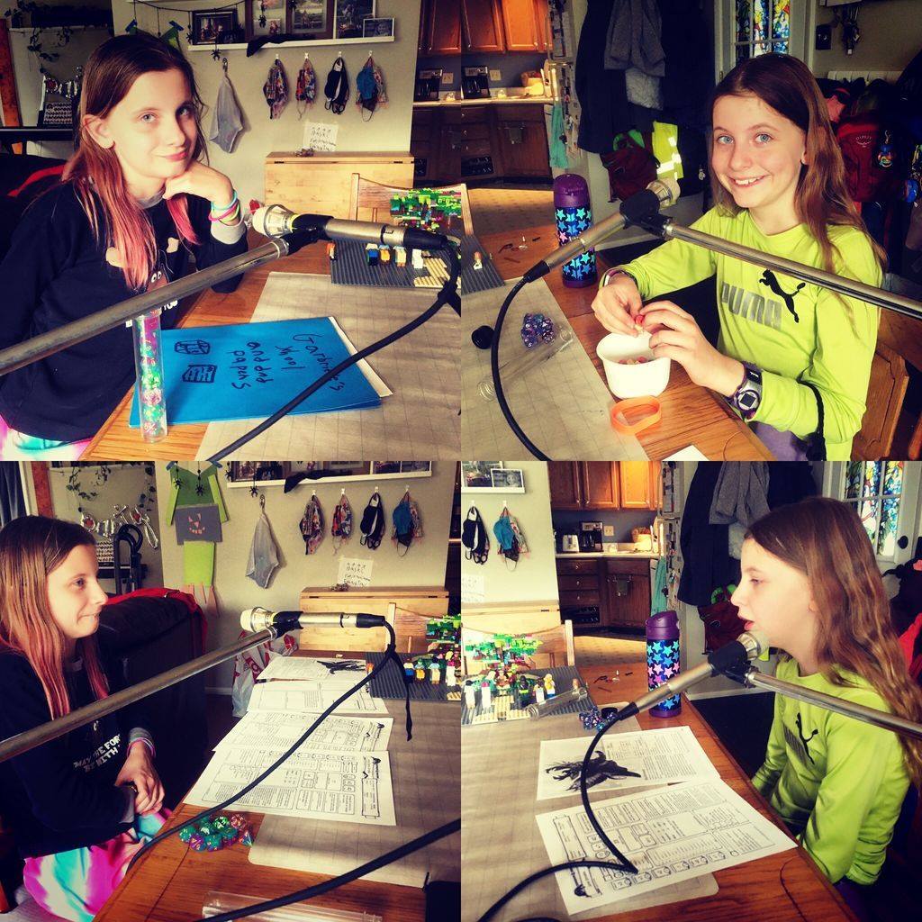 Four photos in a quadrant feature twin girls making podcast. In some of the quadrants they are looking at the camera, in others they are not. They are seated at a big table with microphones and papers and dungeons and dragons style dice. Photo courtesy of Grant Thomas. 