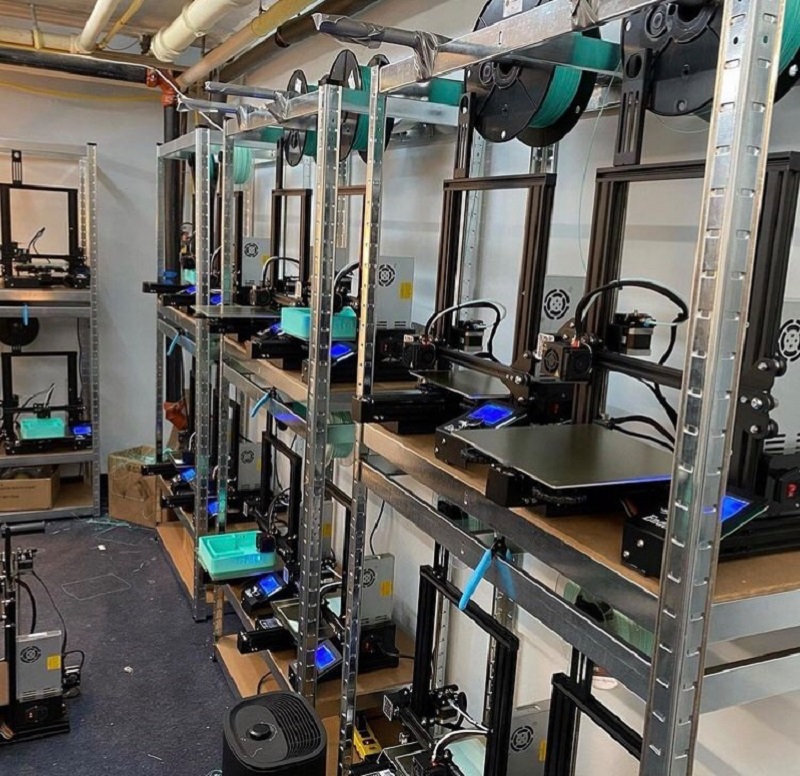 3D printers neatly organize along the wall in various stages of printing. Photo courtesy of Judy Lee and Made in Urbana