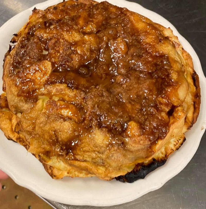 A thick, dense-looking pancake stuffed with apples and topped with a caramelized sauce. Photo courtesy of Original Pancake House in Champaign.
