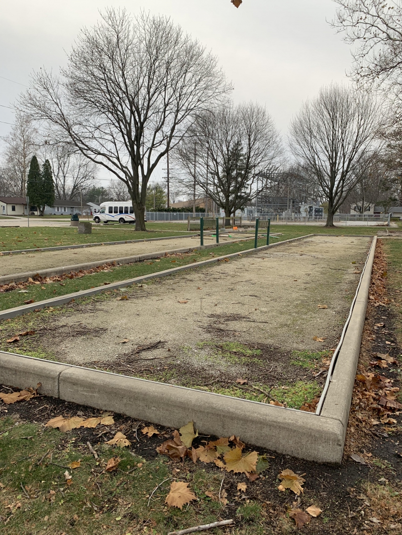 two bocce ball courts sit in a park 