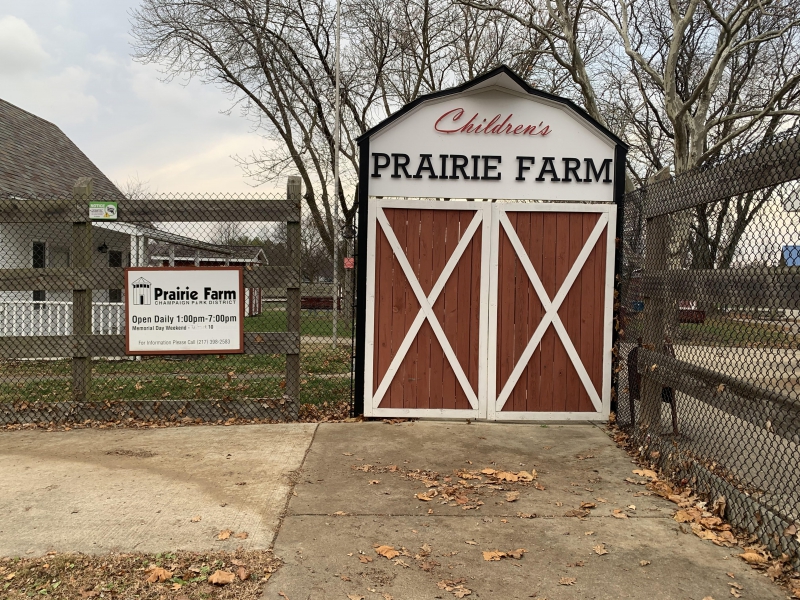 the entrance of Prairie Farm with a red barn serving as its gate